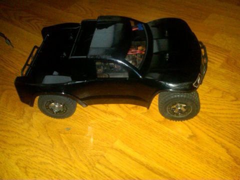 1986 Ford Bronco - Black remote control truck body with visible interior electronics and Supermotors logo.