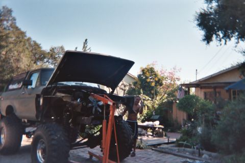 1978 Ford Bronco - Working on the engine of a 1978 Ford Bronco in a residential driveway.