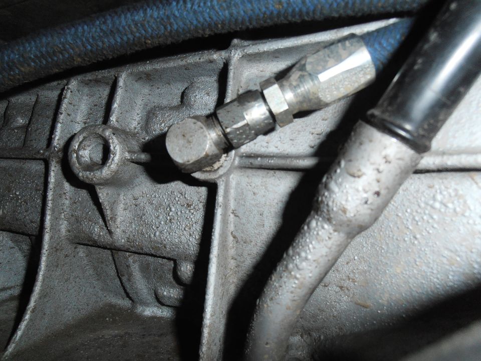 close-up of transmission fluid line fitting attached to metal casing