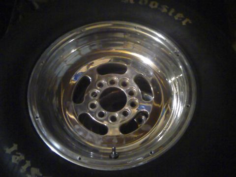 1966 Ford Fairlane - Close-up of a chrome wheel with a five-spoke design, set against a tire.