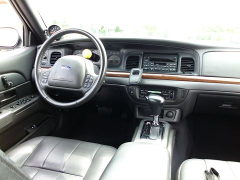 2004 Ford Crown Victoria - The interior of a 2004 Ford Crown Victoria, leather seats and wood trim accents.