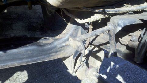 1978 Ford Bronco - Close-up view of the underbody suspension components, showing various metal parts and wiring.