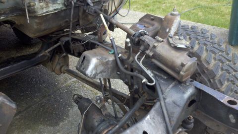 1978 Ford Bronco - The underside of a vehicle chassis is shown, focusing on the steering mechanism and suspension components.