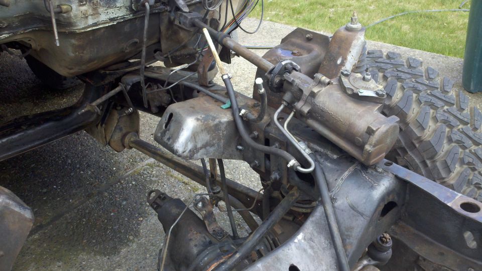close-up of vehicle frame with steering box and suspension parts
