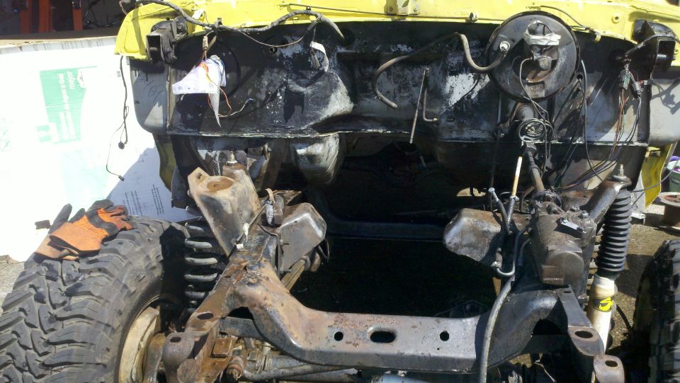 Yellow 1978 Ford Bronco chassis with engine and suspension visible