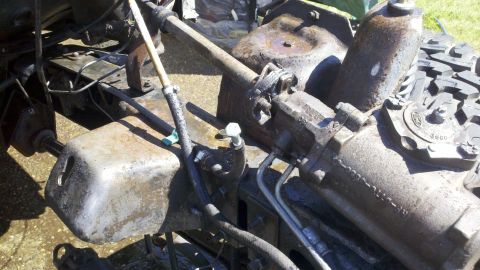 1978 Ford Bronco - Rusty steering gear assembly with visible text and hydraulic lines.