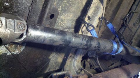 1978 Ford Bronco - Vehicle driveshaft held in place with tie-down straps.