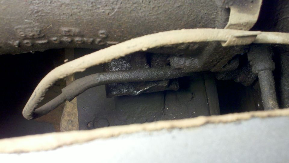 close-up of vehicle undercarriage with brake lines and frame