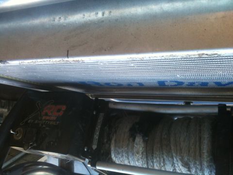 1966 Ford Bronco - Close-up view of a Smittybilt XRC winch and vehicle radiator assembly.