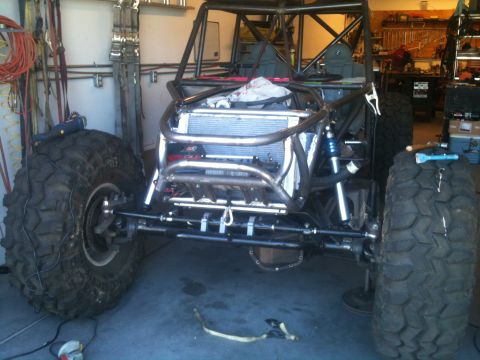 1966 Ford Bronco - Custom off-road buggy chassis under construction, a prominent roll cage and oversized tires.