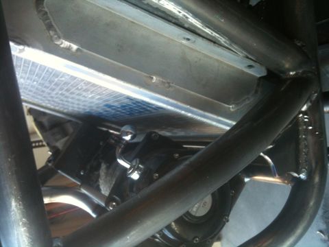 1966 Ford Bronco - Close-up view of a radiator and fan assembly, surrounded by metal tubing, likely from a custom vehicle.