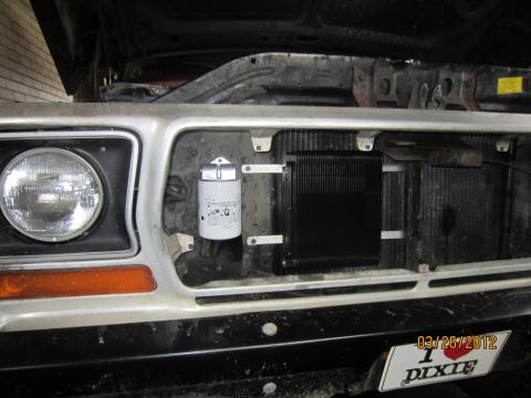 1979 Ford Bronco - Close-up of the front grille area of a 1978 Ford Bronco, showing engine components and a date stamp.