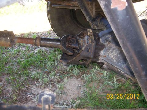 1982 Ford F-100 - Close-up view of a vehicle's driveshaft and differential assembly, showing the U-joint connection.