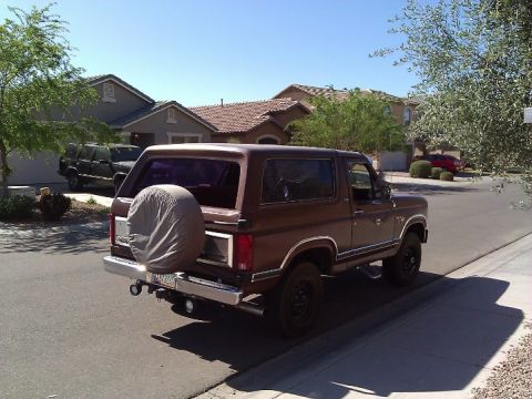 1981 Ford Bronco - This 1980s Ford Bronco is parked on a suburban street, showing its rear and side profile.