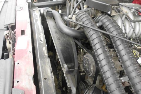 1994 Ford Bronco - Close-up view of engine bay components including fan shroud and air intake hoses.