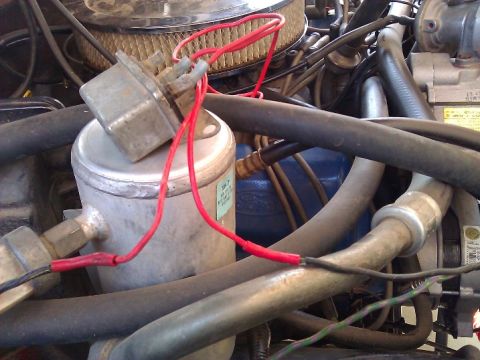 1981 Ford Bronco - Close-up view of engine bay components, including wiring and air conditioning parts, with some readable text on a sticker.