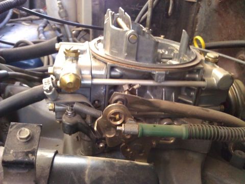 1981 Ford Bronco - A detailed view of a vehicle's carburetor and associated engine components.