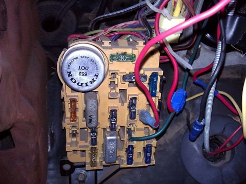 1981 Ford Bronco - The vehicle's fuse box is shown with various fuses and wiring connected.