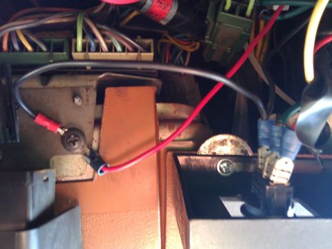 1981 Ford Bronco - A close-up view of a vehicle's interior wiring harness shows various colored wires and connectors.