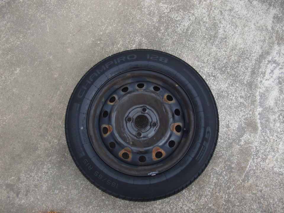 Spare tire with 185/65 R15 tire on a steel rim with rust spots