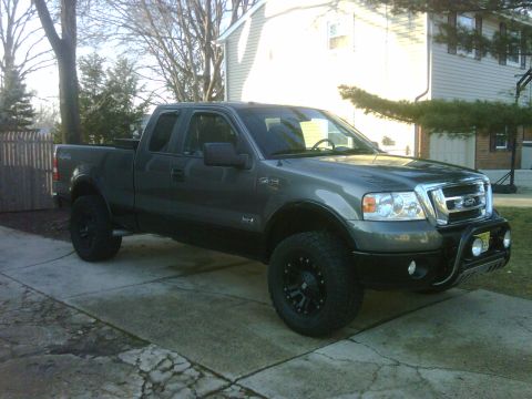 2008 Ford F-150 - This pickup truck has a custom bull bar with fog lights and large off-road tires.