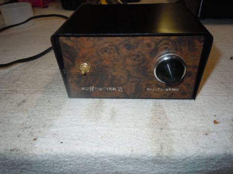 1980 Pontiac Trans Am - Fuzzbuster II multi-band radar detector shown with a woodgrain faceplate and a black control knob.