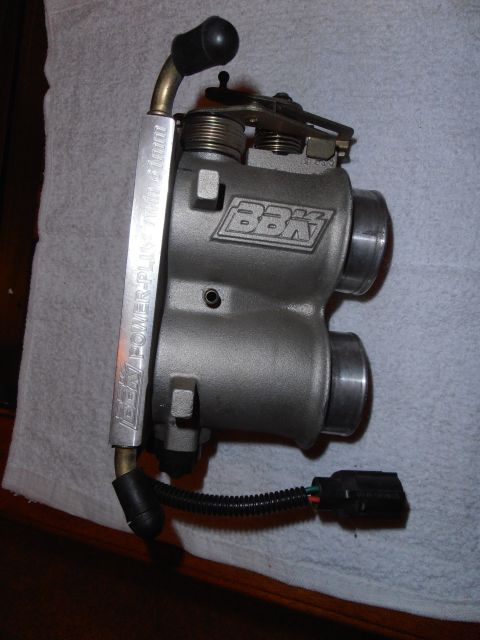 1990 Ford Bronco - A close-up view of a BBK throttle body, showing its brand name and specifications.