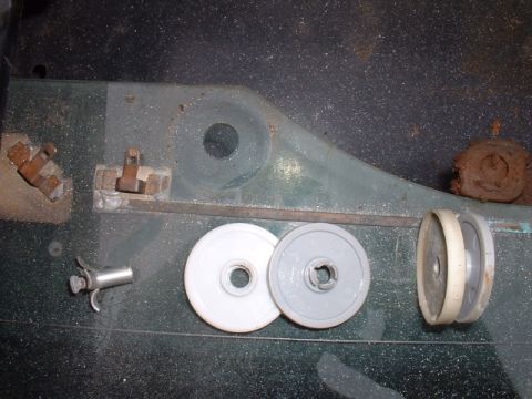 1986 Ford Bronco - Various mechanical parts and a tool are visible on a dark surface.