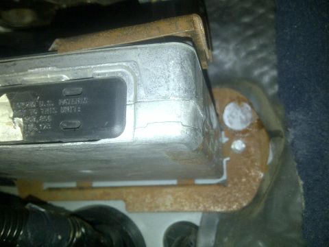 2000 Ford Crown Victoria - An electronic control unit is visible, mounted with rusty brackets, showing patent information on its label.