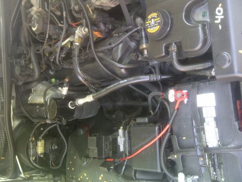 2000 Ford Crown Victoria - Close-up view of a vehicle's engine compartment, showing various components and wiring.