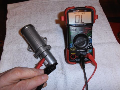 1990 Ford Bronco - Digital multimeter in resistance mode reading OL (open/infinite ohms) during a continuity test of an automotive electrical connector/sensor.