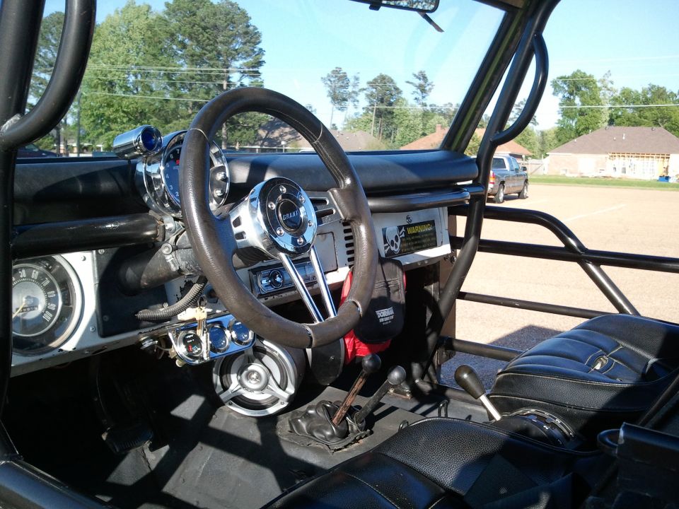 Early Ford Bronco interior with roll cage, Grant steering wheel and floor shifters