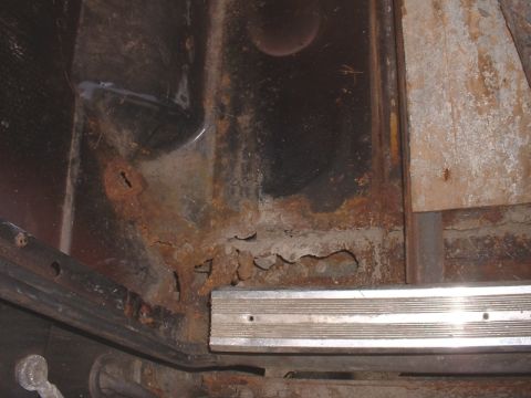 1986 Ford Bronco - Interior metal shows significant rust damage and corrosion, with a visible trim piece.