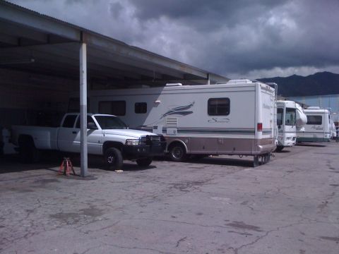 1997 Dodge 3500 - A white 1997 Dodge 3500 pickup truck is parked under a covered area, with multiple RVs behind it.