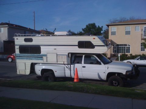 1997 Dodge 3500 - This 1997 Dodge 3500 pickup truck is equipped with a camper shell, suggesting it's set up for travel.