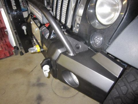 2008 Jeep Wrangler - Close-up of an aftermarket front bumper tow hooks and an integrated LED light bar.