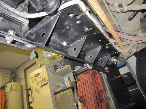 2008 Jeep Wrangler - Custom brackets installed on the underbody of a vehicle, with various wires and hoses present.