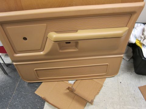 1987 Dodge 1500 - Tan interior door panel from a truck, likely from the 1980s or 1990s.