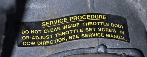 1990 Ford Bronco - A service sticker provides instructions for throttle body maintenance.