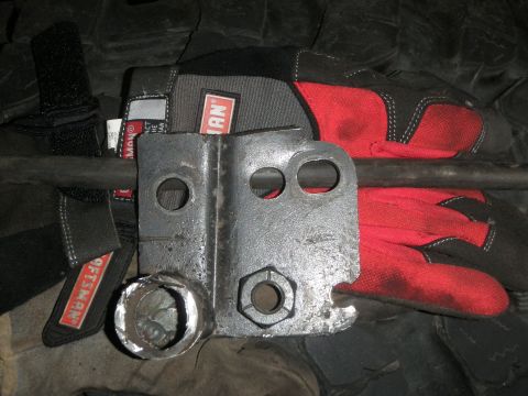 1961 International Scout 800 - A metal bracket is shown with red and black Craftsman gloves behind it.