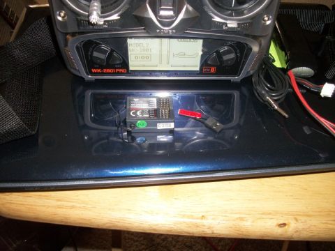 1996 Ford Bronco - A remote control transmitter and its receiver are placed on a dark surface.