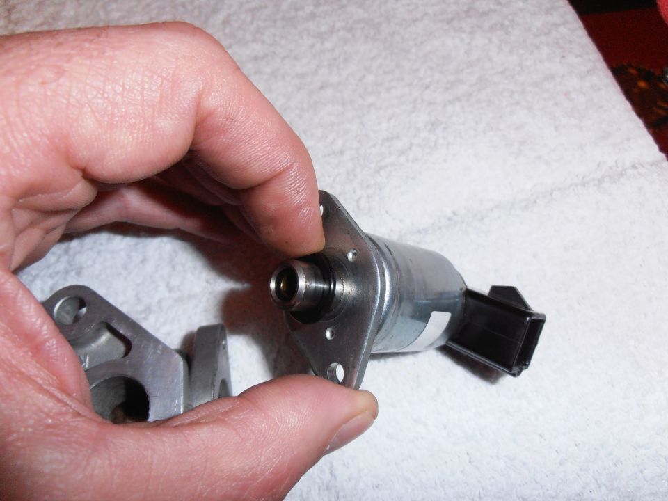 Idle air control valve held by hand