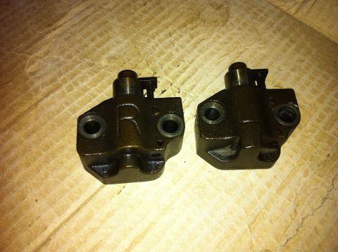 1998 Ford Crown Victoria - Two dark metal timing chain tensioners are shown, one with an 'R' marking.