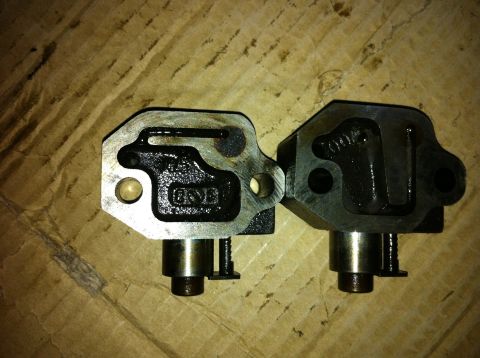 1998 Ford Crown Victoria - Comparison of two timing chain tensioners, one showing signs of wear.