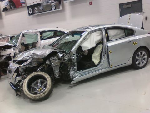 1971 Ford Ranchero - This severely damaged silver sedan has its airbags deployed and trunk open, indicating a recent collision.