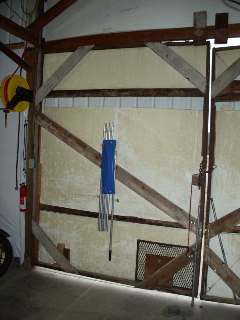 1989 Ford Bronco - Interior view of a garage with a large wooden door and various equipment mounted equipment visible.