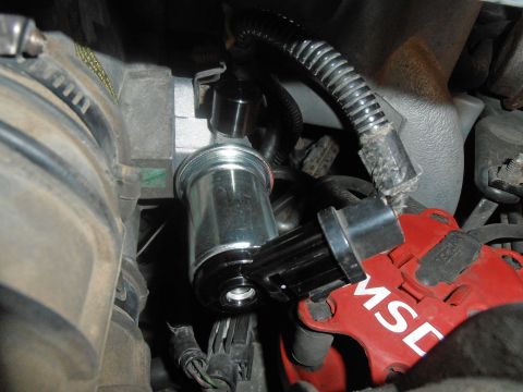 1990 Ford Bronco - Engine components are visible, including a distributor cap and a valve, with some readable text on the cap.