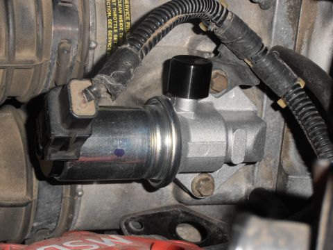 1990 Ford Bronco - This image shows a close-up view of an engine idle air control valve, a critical component for regulating engine speed.
