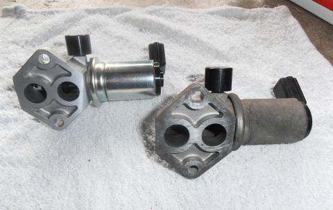 1990 Ford Bronco - Comparison of a new and used idle air control valve for a vehicle.