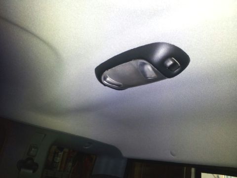 2011 Ford Ranger - The interior dome light assembly is visible against the gray headliner of the vehicle.